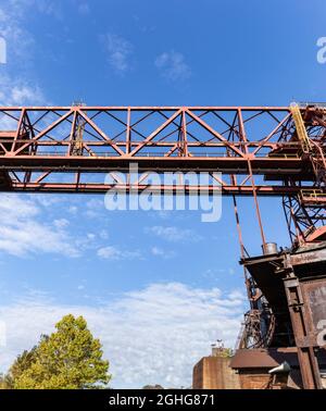 Large panorama of overhead trolley system on the exterior of a steel manufacturing facility, Rivers of Steel, vertical aspect Stock Photo