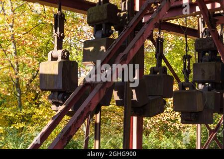 Rusting metal industrial architecture set against a fall landscape, horizontal aspect Stock Photo
