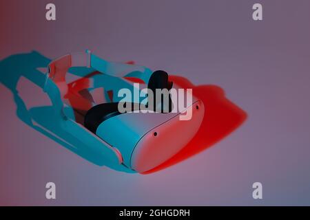 Virtual reality helmet on white background in neon light. VR, future, gadgets, technology concept. Stock Photo