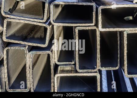 Metal pipes made of rectangular profile in a commercial warehouse Stock Photo