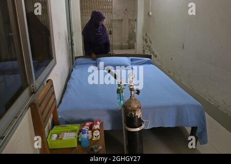 Non Exclusive: DHAKA, BANGLADESH - SEPTEMBER 6: A woman prepares the bed  inside of an  isolation area, as preventive measure in case a student falls Stock Photo