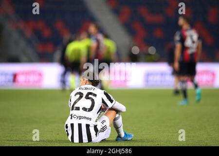 Bologna, Italy, 23rd May 2021. Adrien Rabiot of Juventus sits on the pitch following the final whistle waiting for new from results elsewhere to understand if the team would qualify for the UEFA Champions League during the Serie A match at Renato Dall'Ara, Bologna. Picture credit should read: Jonathan Moscrop / Sportimage via PA Images Stock Photo