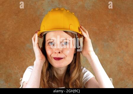 Female industrial worker working in construction industry wearing protective helmet Stock Photo