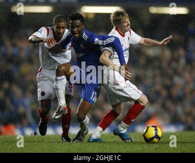 Chelsea's Mikel tussles with Wolves' Karl Henry and Andrew Keogh during Barclays Premier League match between Chelsea and Wolverhampton Wanderers at Stamford Bridge in London. Stock Photo