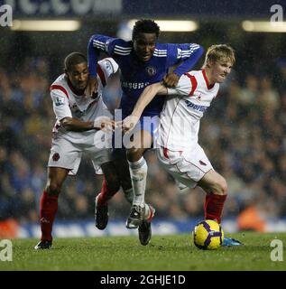 Chelsea's Mikel tussles with Wolves' Karl Henry and Andrew Keogh during Barclays Premier League match between Chelsea and Wolverhampton Wanderers at Stamford Bridge in London. Stock Photo