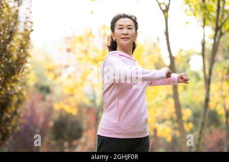 Happy senior woman exercising in the park Stock Photo