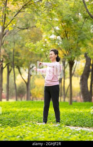 Happy senior woman exercising in the park Stock Photo