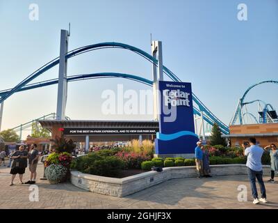 The entrance of Cedar Point with the Gatekeeper ride over the top in the evening with a sunset. Stock Photo