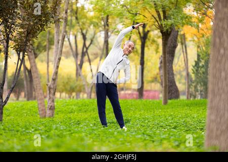 Happy senior man exercising in the park Stock Photo