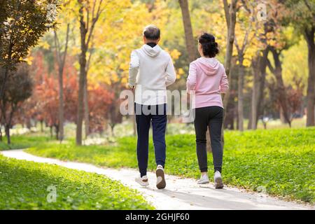 Happy senior couple running in the park Stock Photo