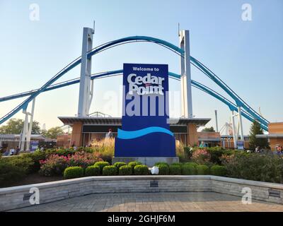 The entrance of Cedar Point with the Gatekeeper ride over the top in the evening with a sunset. Stock Photo