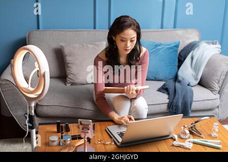 Young woman using laptop at home Stock Photo