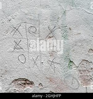 Abstract Tic Tac Toe Game on cement wall, dirty peeling paint. Close-up texture. Natural vintage background Stock Photo