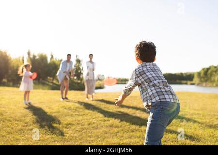 Happy young family relaxing on meadow Stock Photo