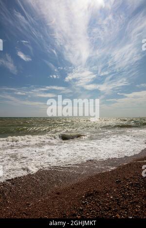 Littlehampton, West Sussex, UK; the East Beach.A summer late afternoon with sea-foam and a dramatic cloudscape Stock Photo