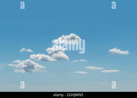 Blue summer sky with many white cumulus clouds texture background with copy space for text  Stock Photo