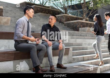 Business people having a meeting outdoors Stock Photo