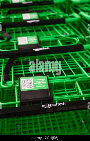 Factoria, WA, USA - September 06, 2021; Green grocery carts close up outside the Amazon Fresh location in Factoria Washington Stock Photo