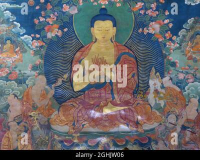 Wall mural painting of The Buddha in Dharmchakra (Teaching of The Wheel of Dharma) mudra or pose, Jokhang Temple, Lhasa, Tibet Stock Photo