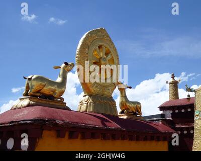 A pair of deer flanking the eight-spoked Dharma wheel on lotus flower, on the roof of Jokhang Monastery, Lhasa, Tibet