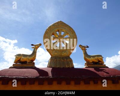 Eight-spoked Dharma wheel on lotus flower, flanked by a pair of deer on the roof of Jokhang Monastery, Lhasa, Tibet