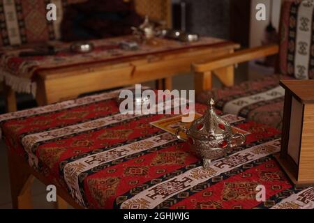 Close-up shot of wooden tables with traditional Middle Eastern tablecloth Stock Photo