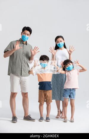 Young family wearing surgical masks Stock Photo