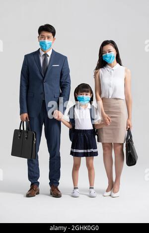 Young family wearing surgical masks Stock Photo