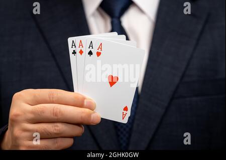 Ace card in the hand of a businessman in a suit. Stock Photo