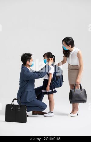 Young family wearing surgical masks Stock Photo