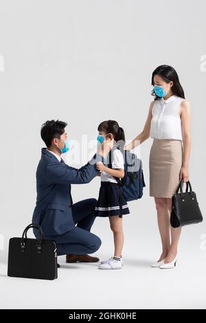 Young family wearing surgical masks Stock Photo