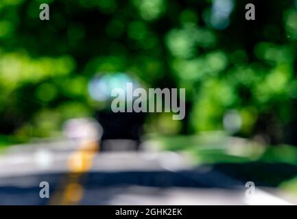 Abstract summer landscape of a vehicle in a blurred green background Stock Photo