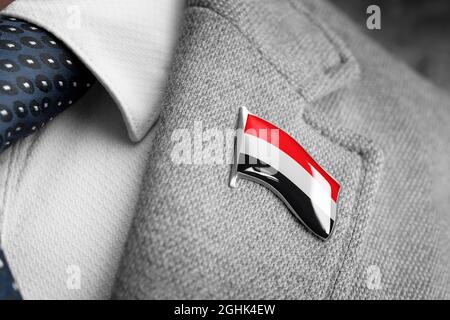 Metal badge with the flag of Yemen on a suit lapel Stock Photo