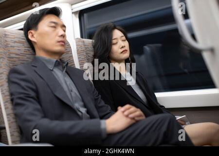 Successful business people resting on high-speed train Stock Photo