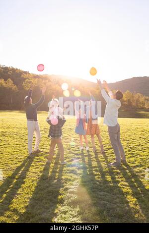 Happy family having fun on meadow Stock Photo