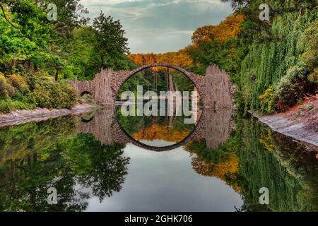 The Rakotzbrücke or Devil's Bridge with its artificially formed basalt columns in Kromlau, East Germany, summer Stock Photo