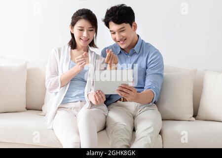 Cheerful young couple using digital tablet Stock Photo