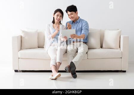 Cheerful young couple using digital tablet Stock Photo