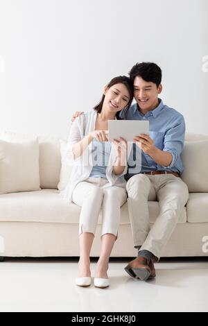 Cheerful young couple using digital tablet Stock Photo