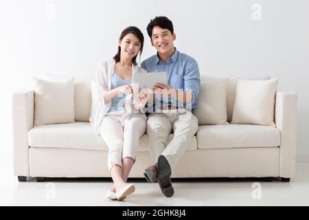 Cheerful young couple using digital tablet Stock Photo