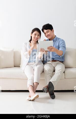 Cheerful young couple using digital tablet Stock Photo