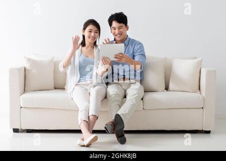 Cheerful young couple using digital tablet Stock Photo