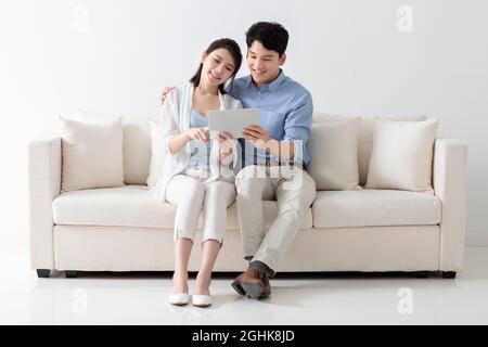 Cheerful young couple using digital tablet Stock Photo