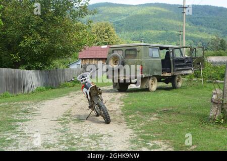 SUV UAZ-452 and motorcycle in the village Stock Photo