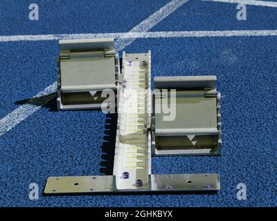 Set of starting block ready for sprint start on athletic stadium. Blue color filter Stock Photo