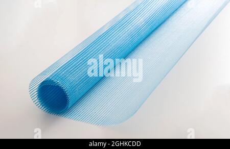 Blue reinforcing construction mesh for wall strengthening on white background, isolate. Stock Photo