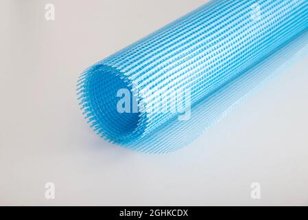 Blue reinforcing construction mesh for wall strengthening on white background, isolate. Stock Photo