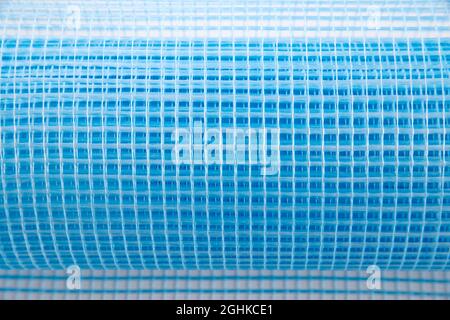 Blue reinforcing construction mesh for wall strengthening on white background, isolate. Stock Photo