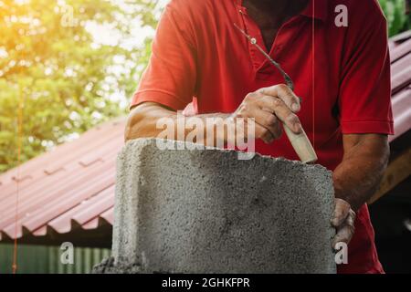 bricklayer man working build for construction at home Stock Photo