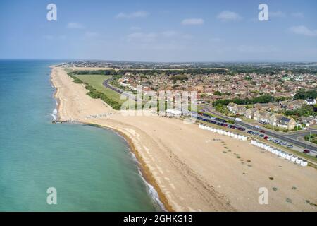 Goring by Sea beach with the Cafe in view and the greensward behind the beach at this popular seaside resort. Aerial view. Stock Photo